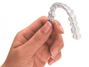 Hand Holding Invisalign Tray