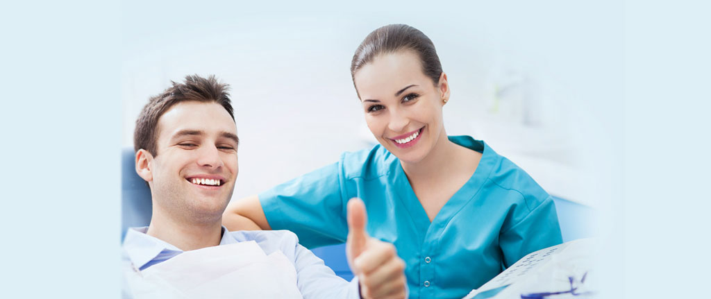 Dentist with Happy Patient in chair
